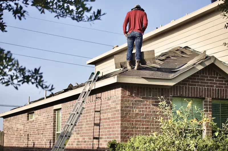 Professional roofer working on a residential roof in Kershaw Acres